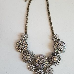 Floral jeweled necklace with iridescent stones.